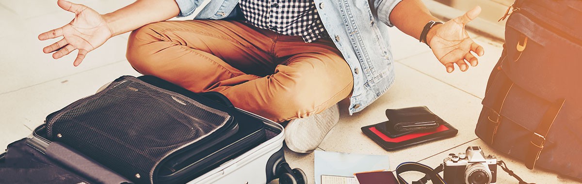 woman packing for a cruise with open suitcase