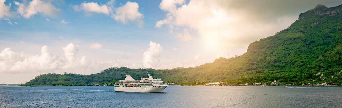 cruise ship coming into a bay in Tahiti
